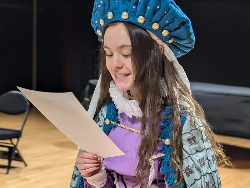 pre-conservatory-pathways-sm girl-in-costume-reviewing-paper